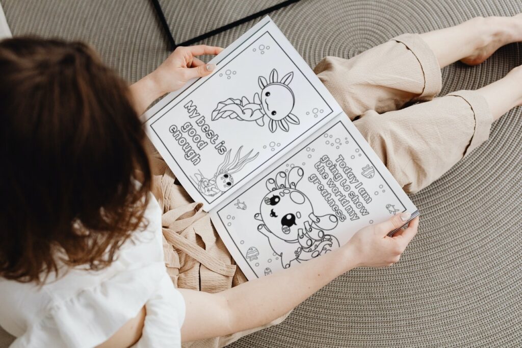 a girl looking at the free axolotl coloring activities