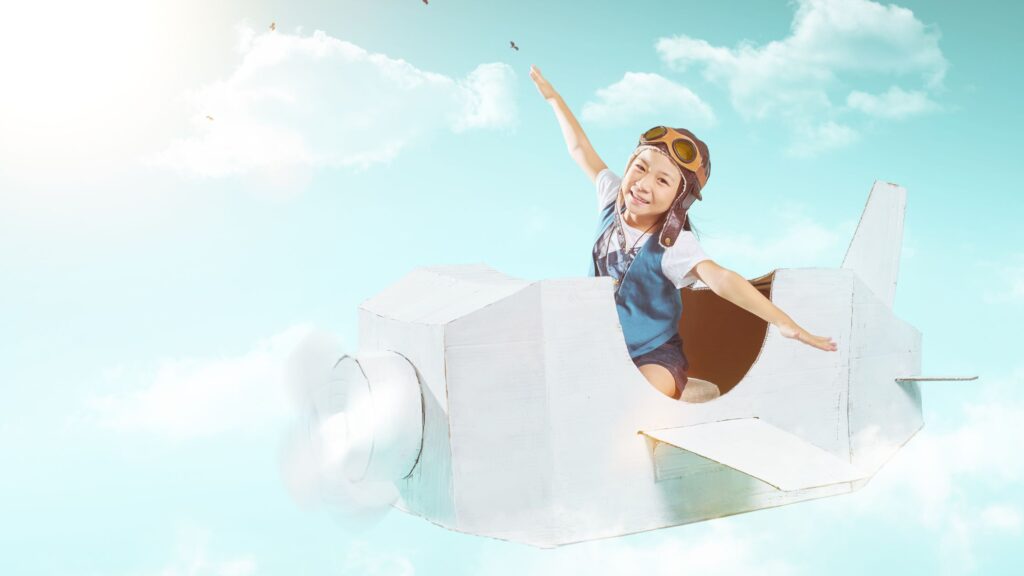 a child flying in a pretend plane