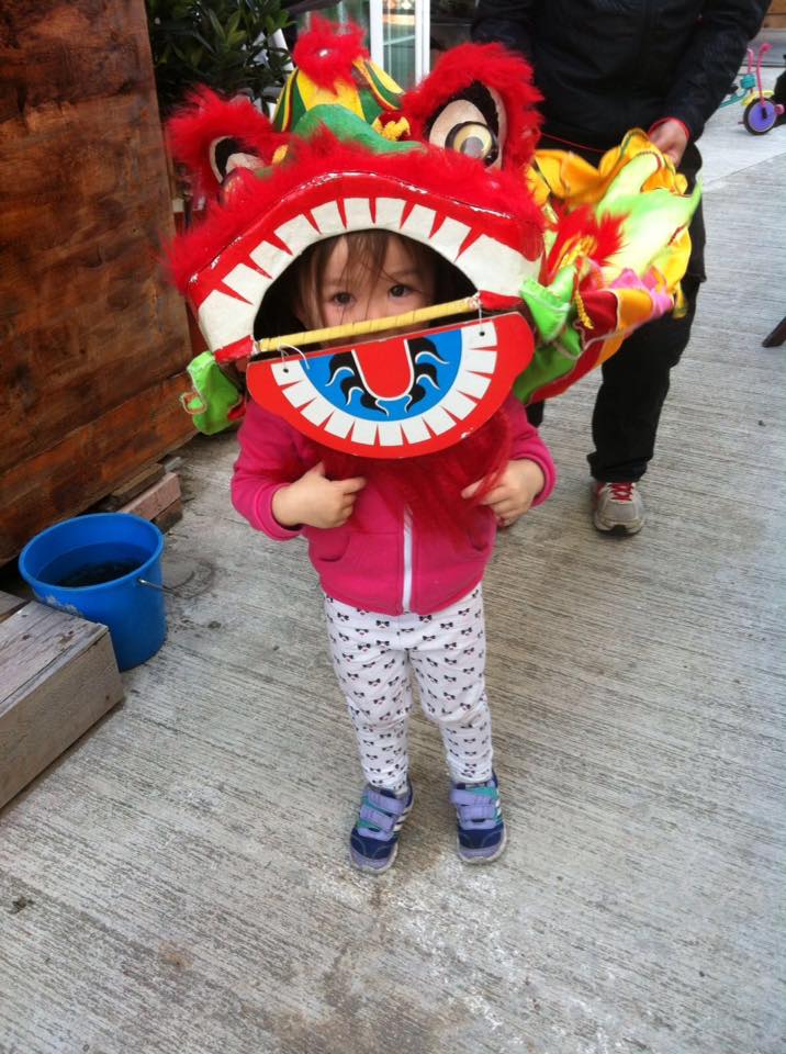 A young girl wearing a lion dance costume