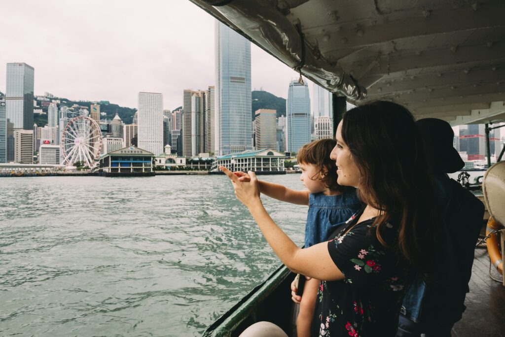 China, Hong Kong, mother and little daughter crossing the river by ferry from Kowloon to Hong Kong I
