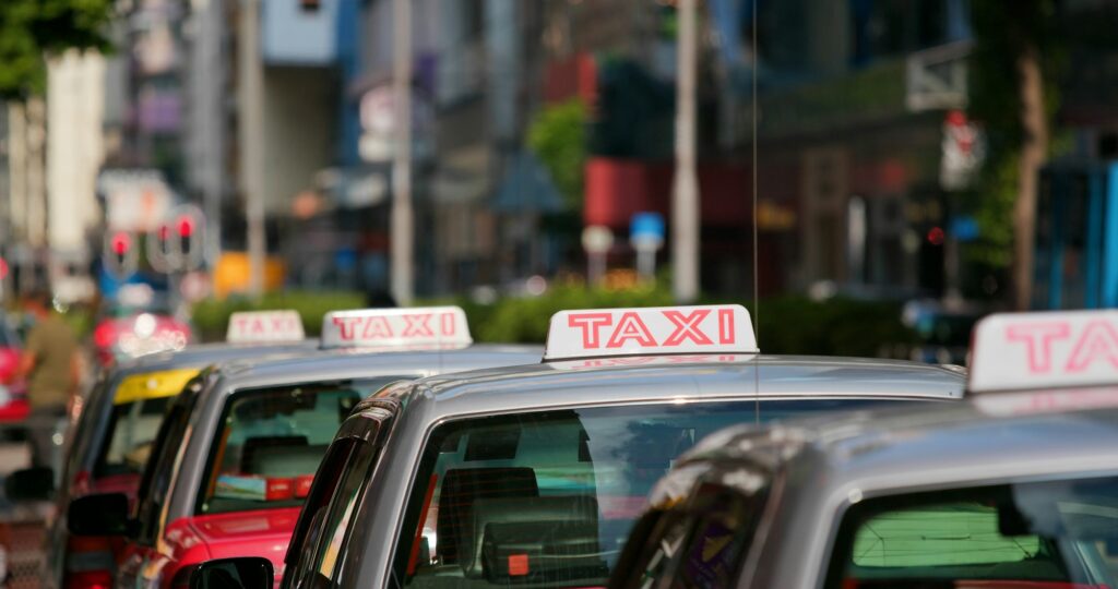 Taxi Sign in red color, moving in city - Moving to Hong Kong: A Relocation Guide for Expat Families